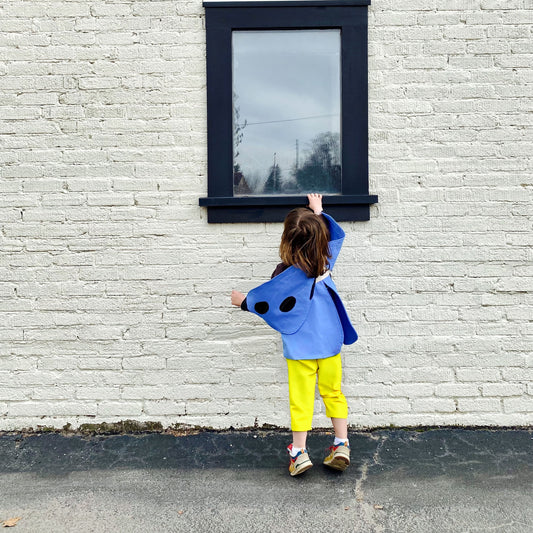 Child wearing natural blue butterfly costume.