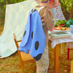 Child in costume with a table and tent in an outdoor setting