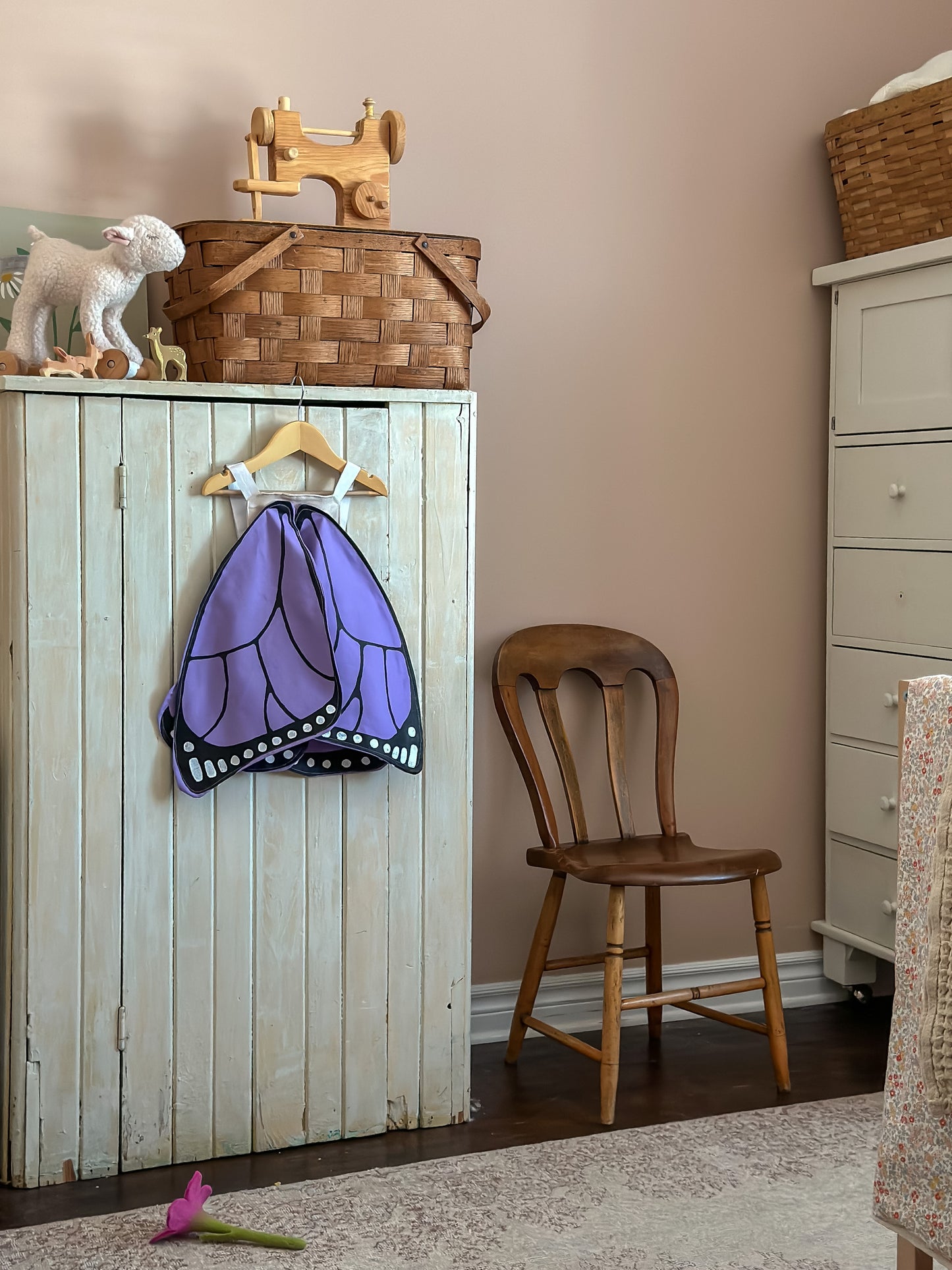 Children's bedroom with purple butterfly wings costume. 