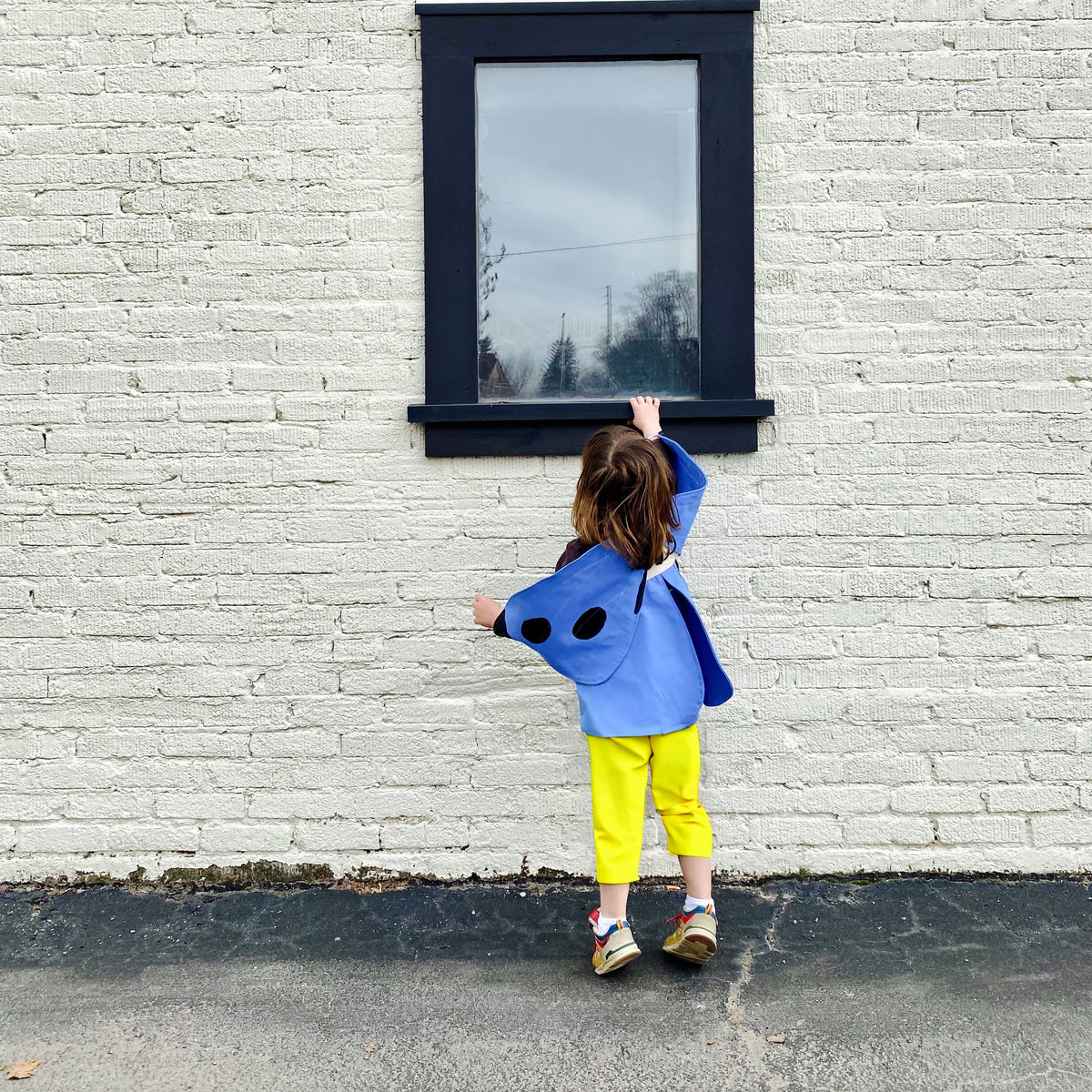 Child wearing natural blue butterfly costume.