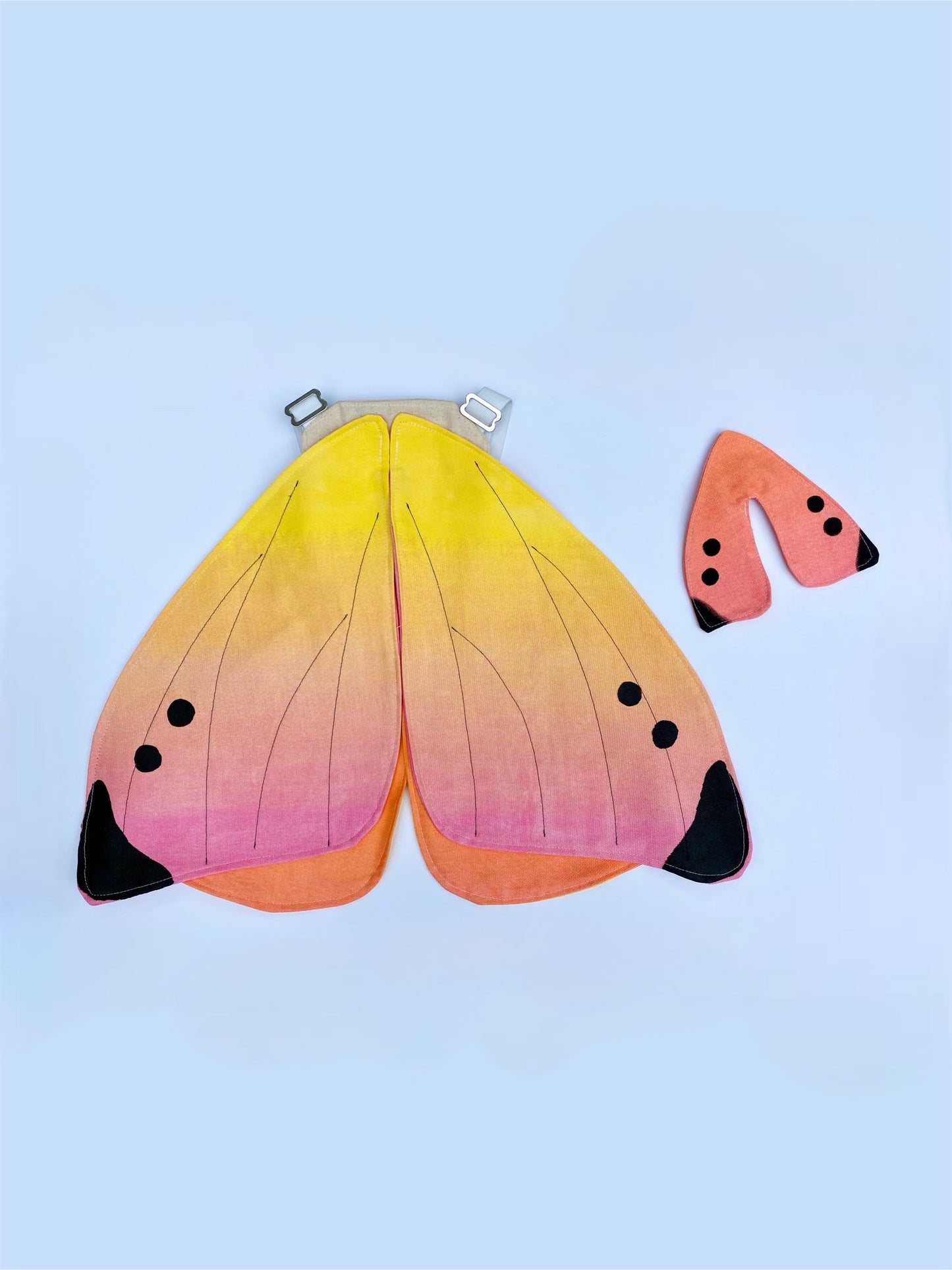 Doll butterfly wings that match child's butterfly fairy wings.